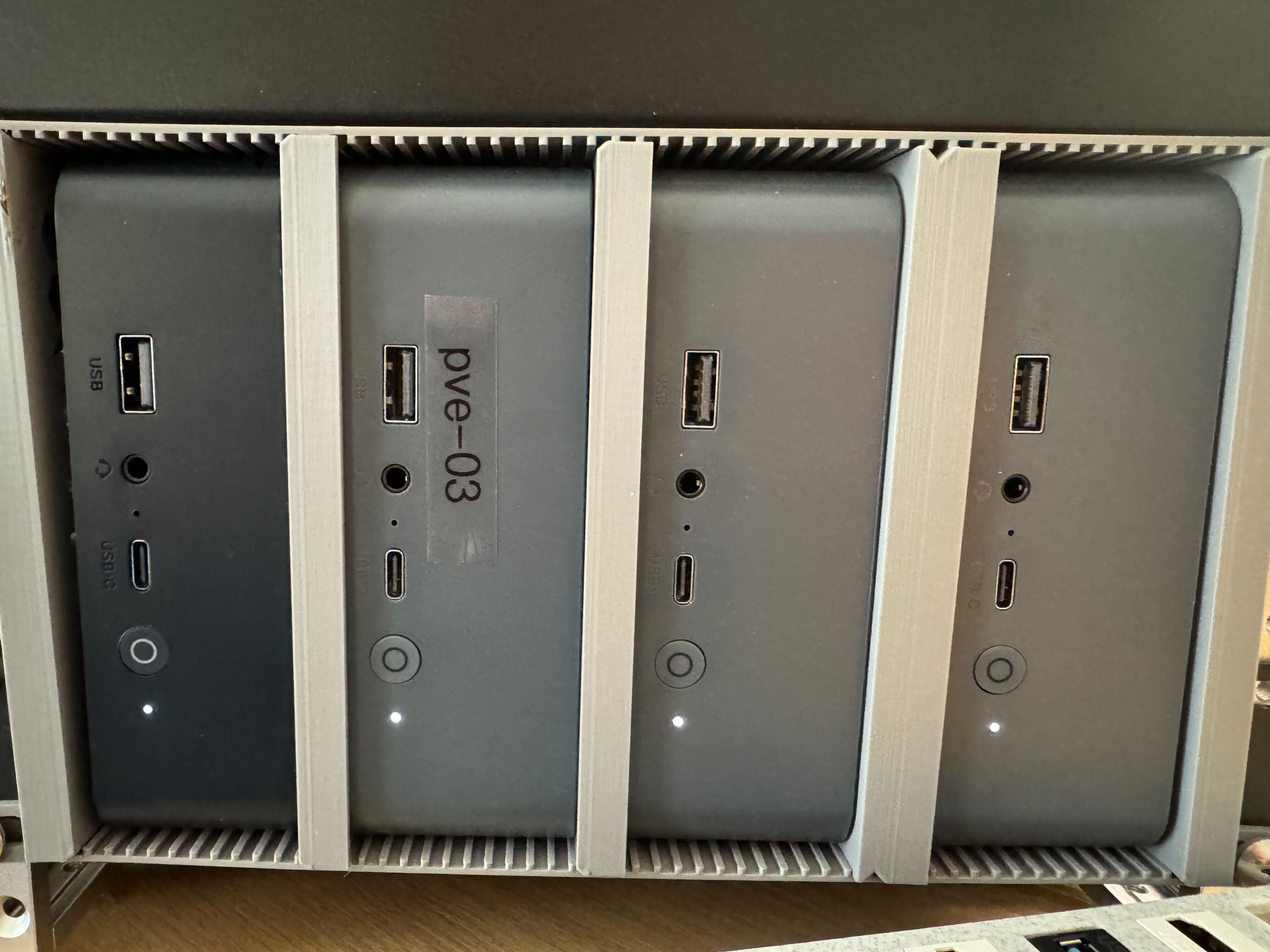 Four mini PCs running Proxmox in a vertical rack